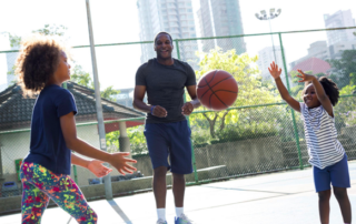 Healthy family playing basketball